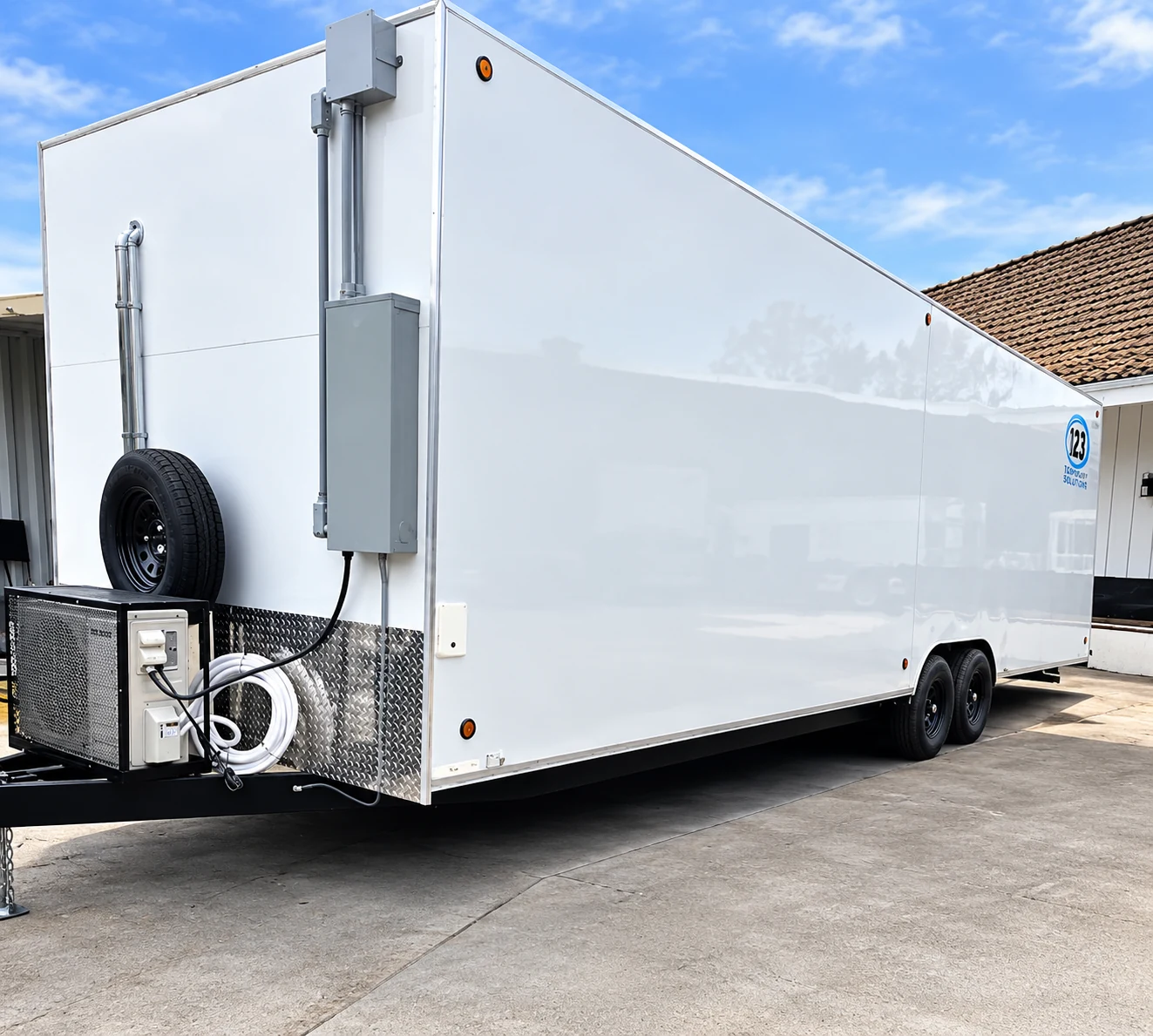 Front three-quarter exterior view of a white 30 ft conveyor dishwashing trailer