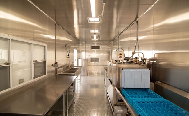 portable dishwashing kitchen drainer tray facing a table